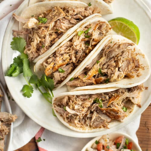 This is a picture of a plate of tacos with slow-cooker pork carnitas.