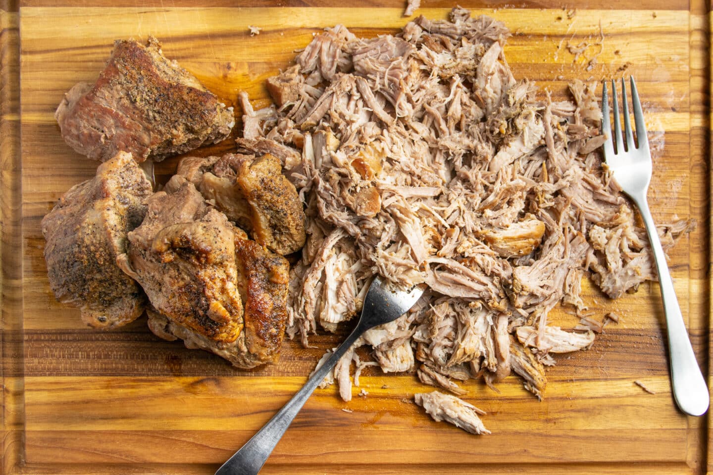 This is a picture of the pork being shredded once it's cooked.