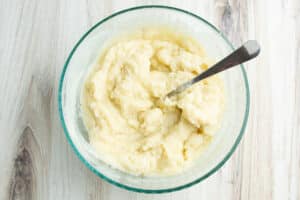 Bowl with mashed potatoes and mashed cauliflower mixed together.