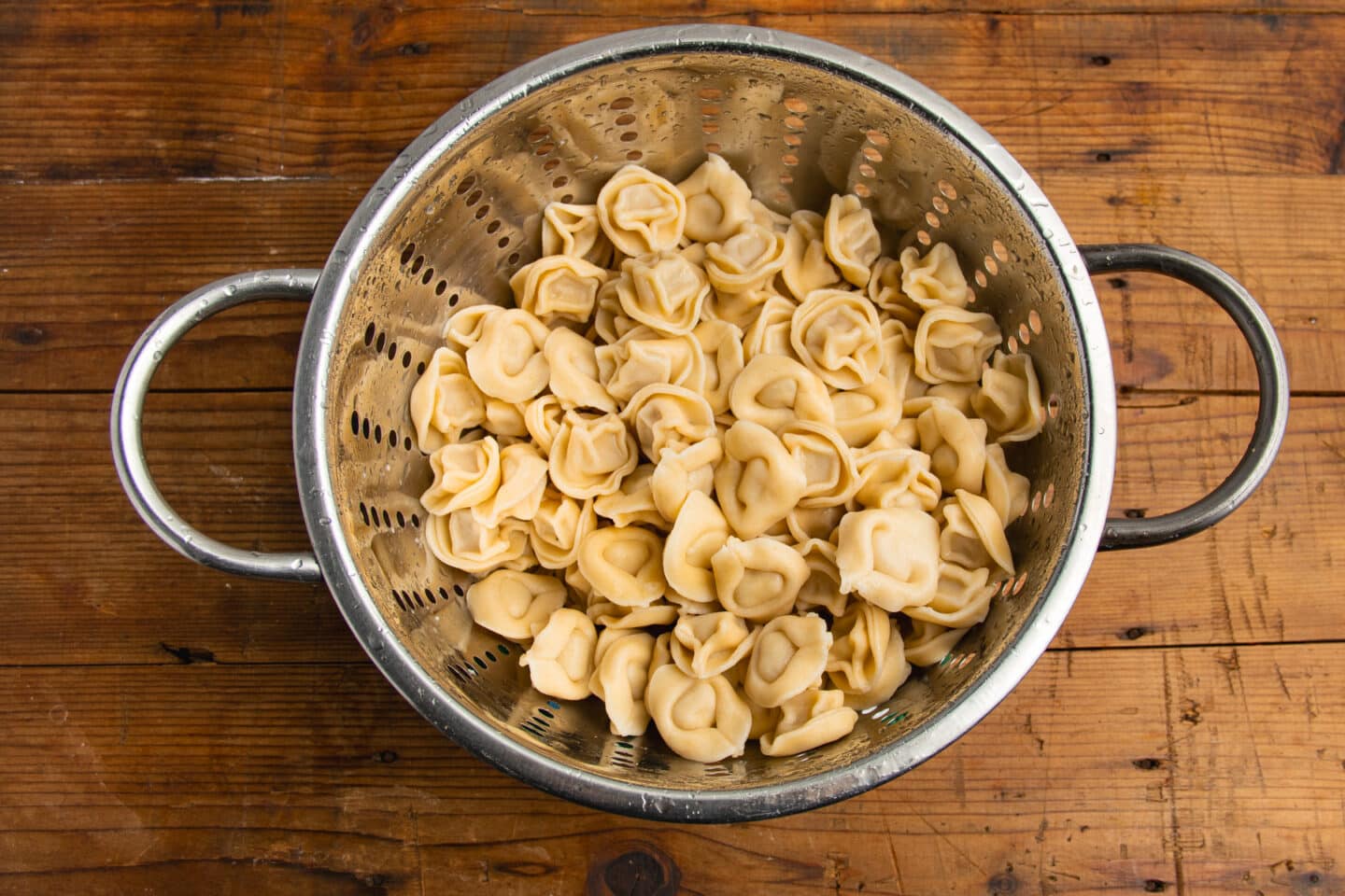 This is a picture of the cooked tortellini in a colander.