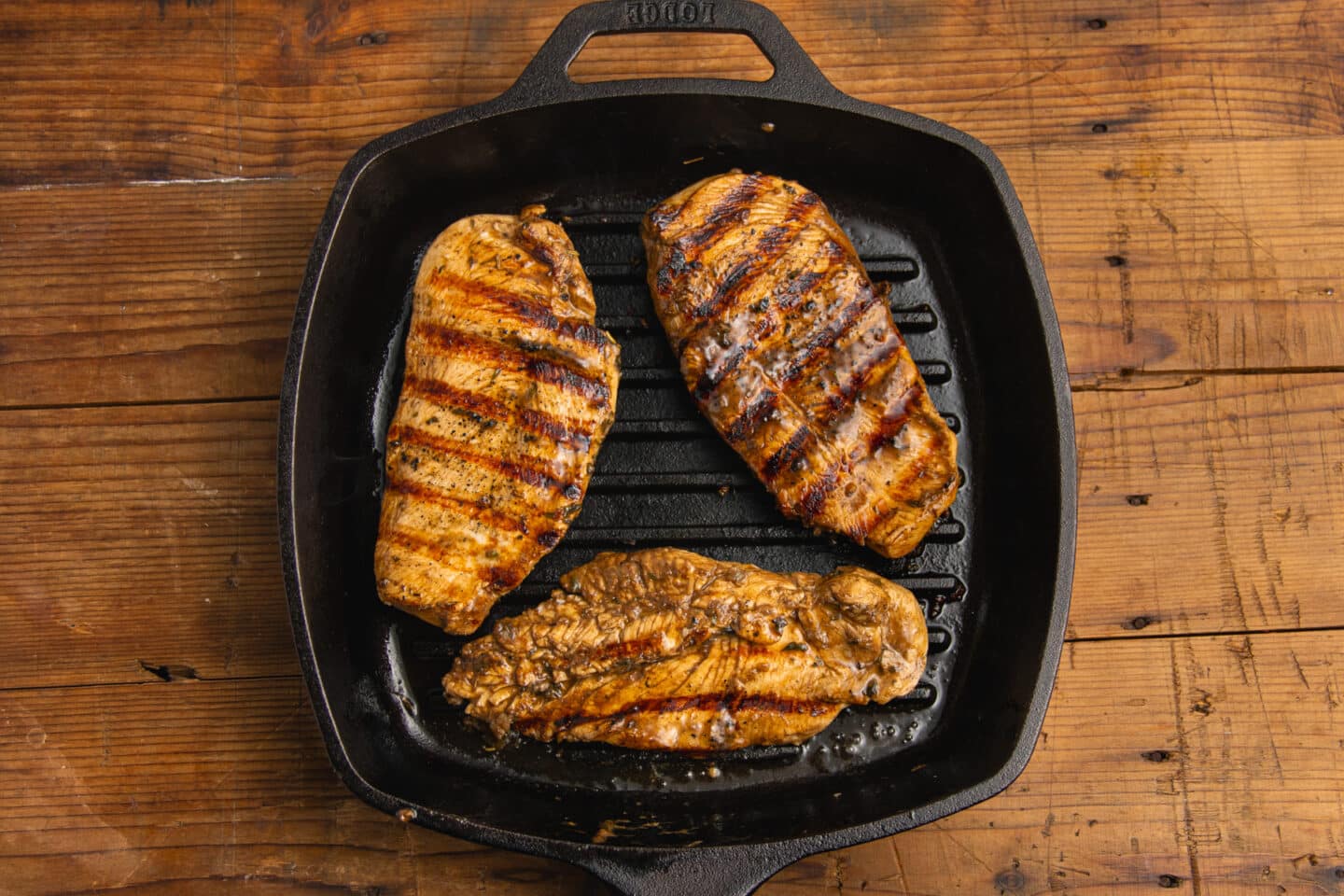 This is a picture of the chicken cooking in a grill pan.
