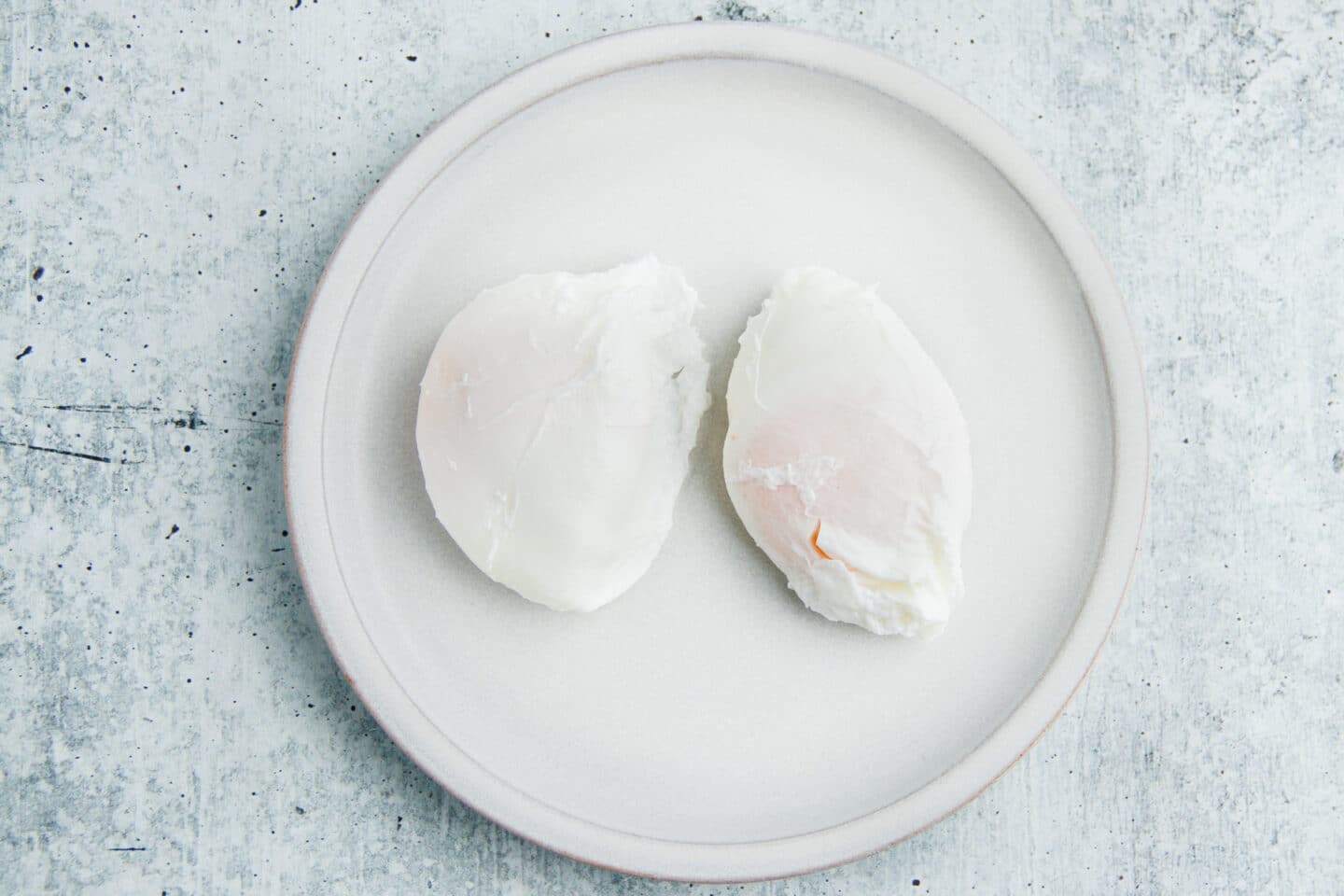 This is a picture of two poached eggs on a plate.