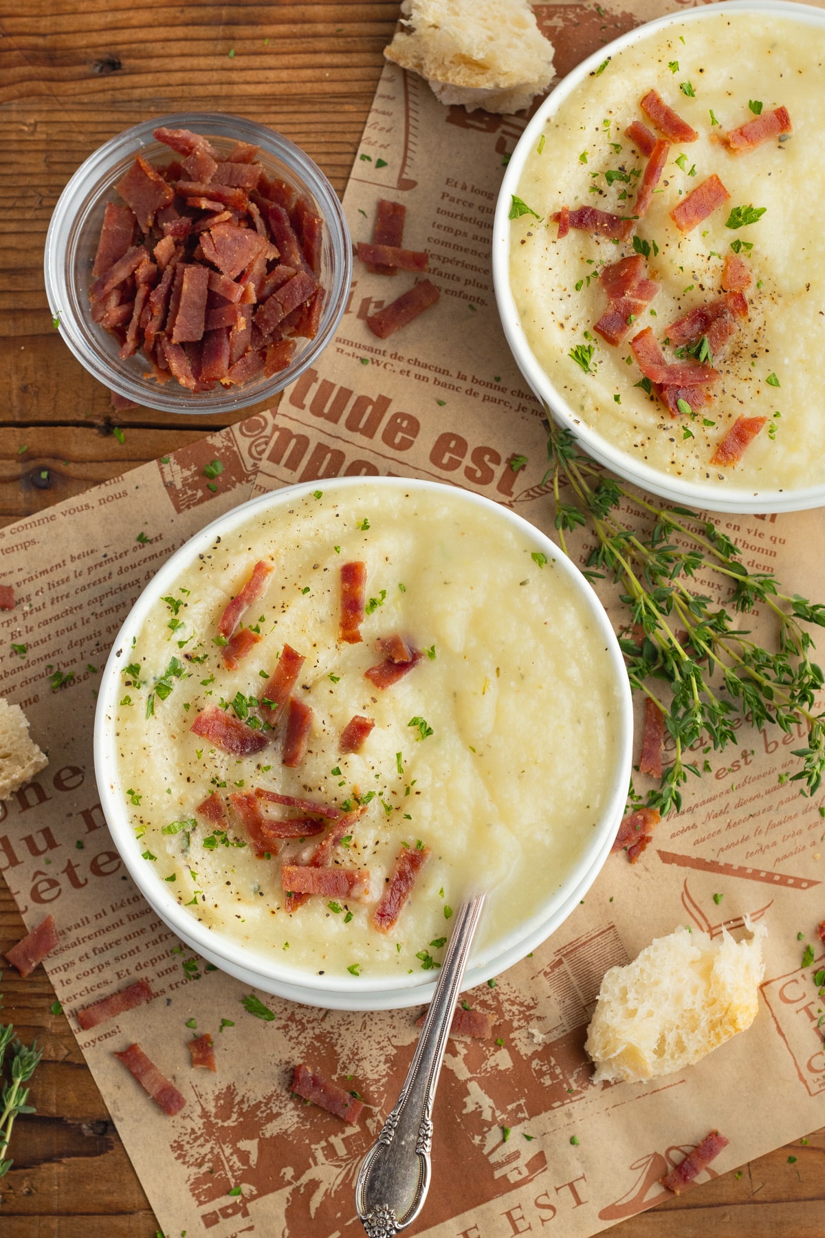 This is a picture of two bowls of soup and one of chopped turkey bacon.