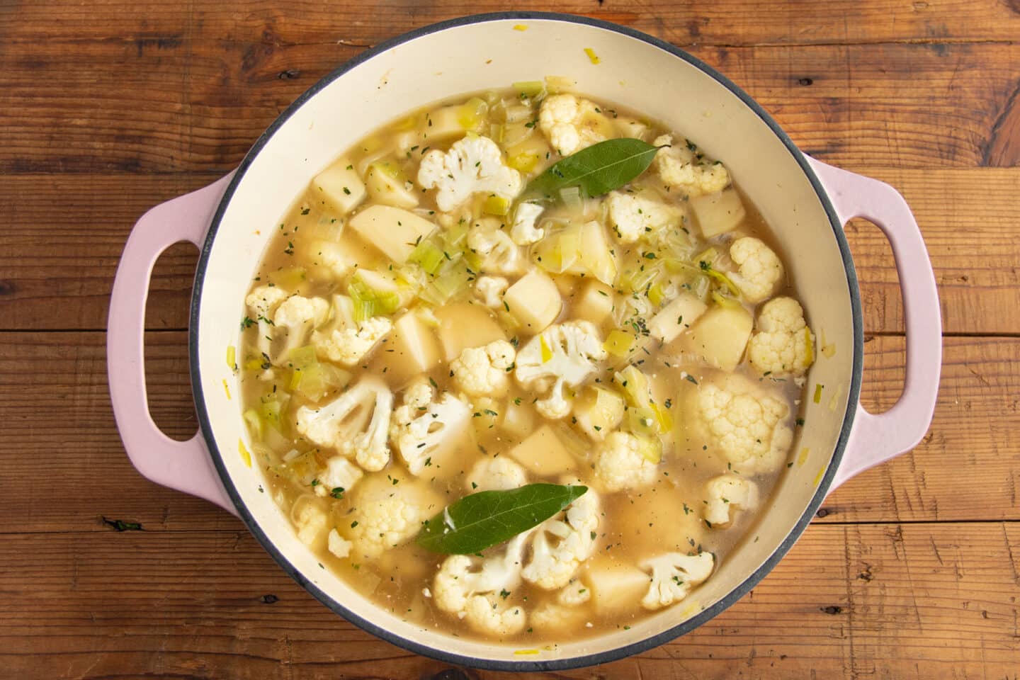 This is a picture of a big pot with the veggies and broth added.