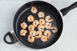 Picture of skillet with shrimp cooking.