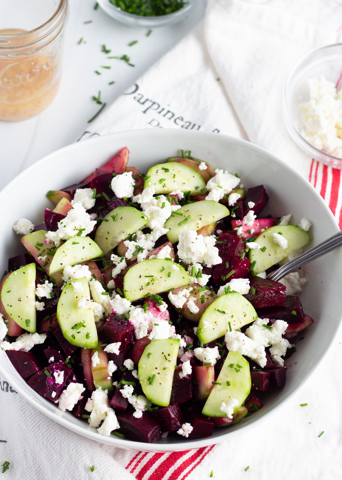 picture of a large bowl with beet cucumber goat cheese salad.