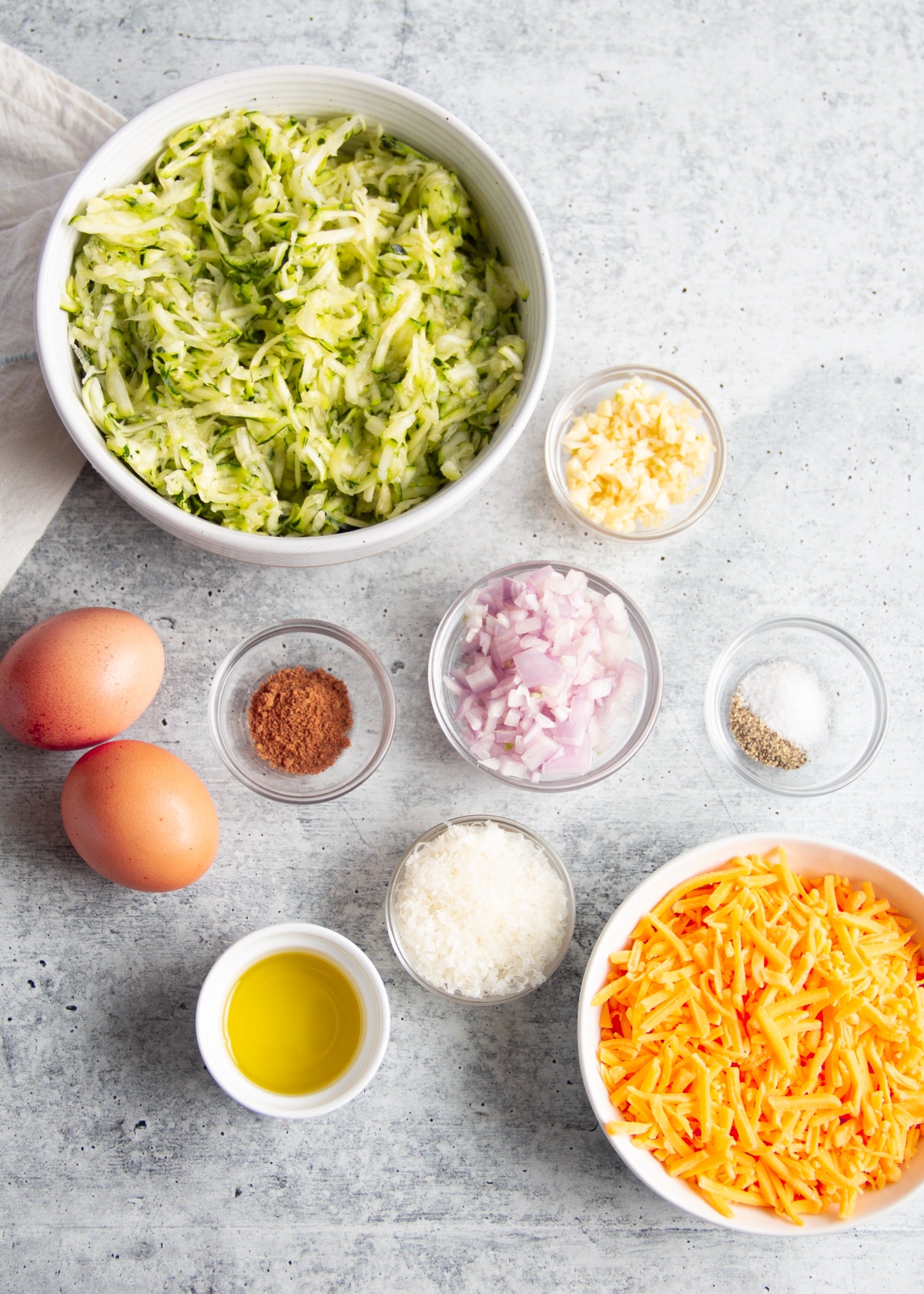 Image of all the ingredients of the cheesy zucchini casserole.