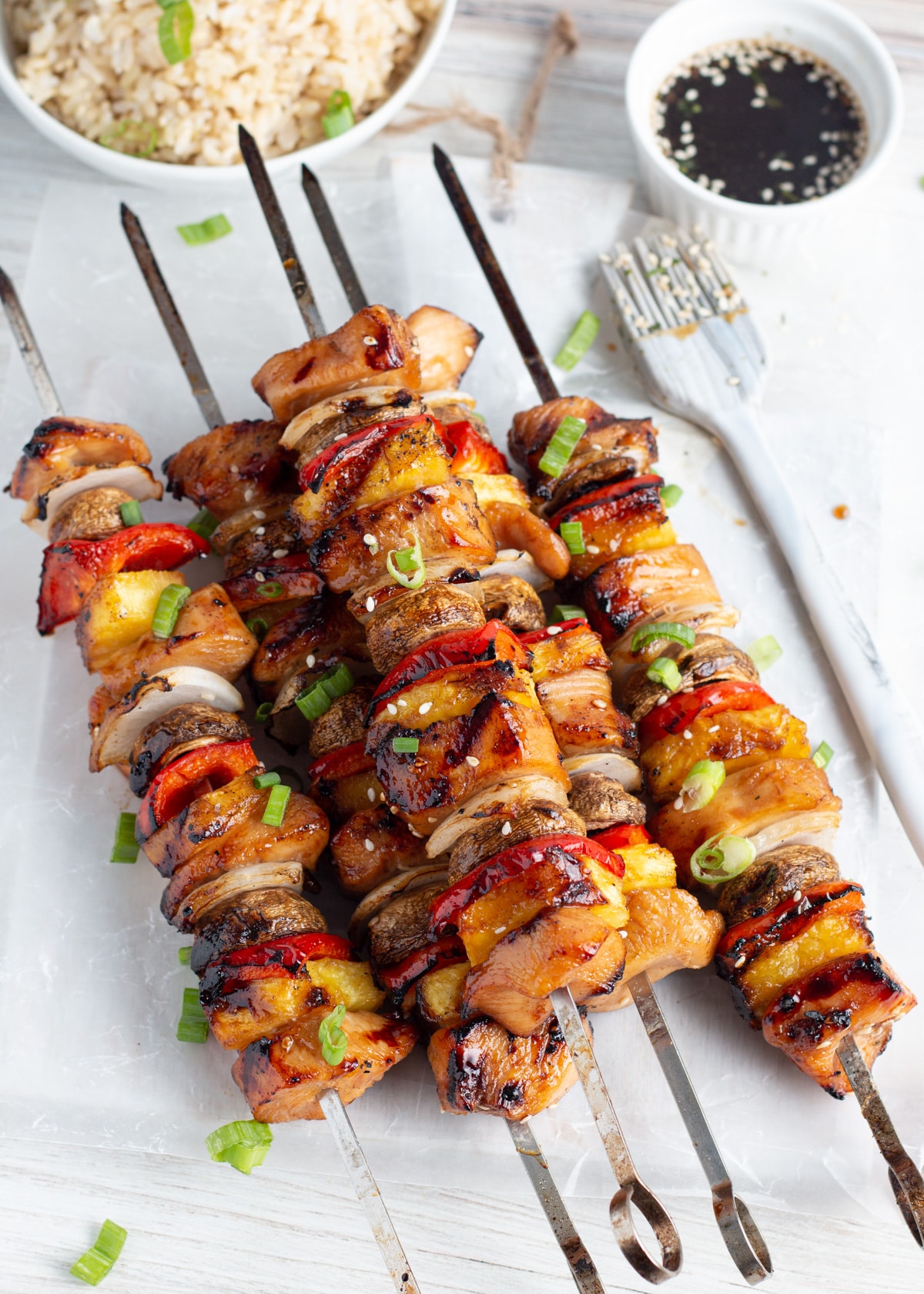 Picture of cooked skewers with chicken, pineapple, mushrooms, onion and peppers.