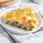 This is a square picture of a slice of quiche.