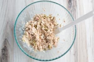 Picture of bowl with tuna added to dressing.