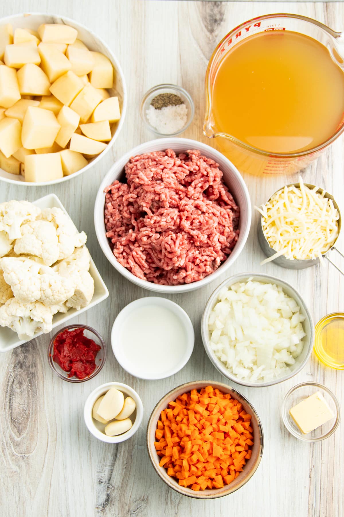 Picture of all individual ingredients in small bowls to make hachis parmentier. 