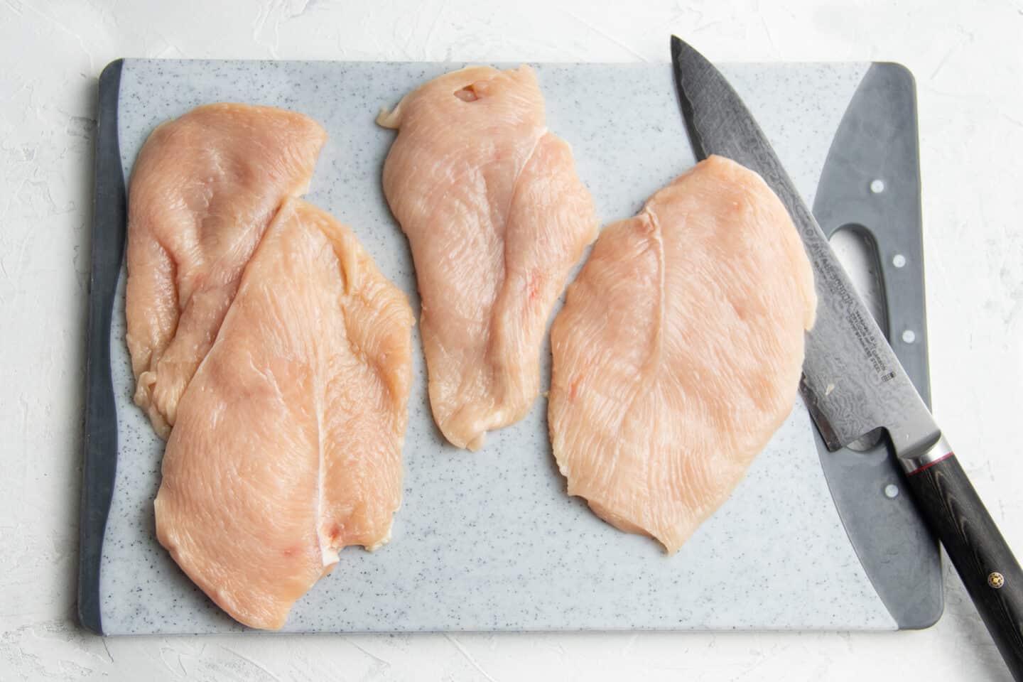 Photo of raw chicken breast.