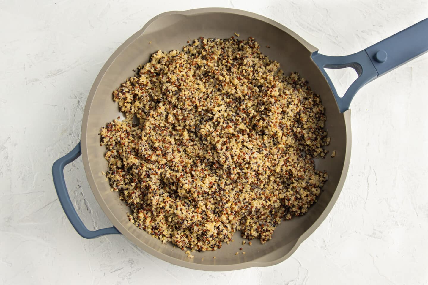 Cooked quinoa in skillet.