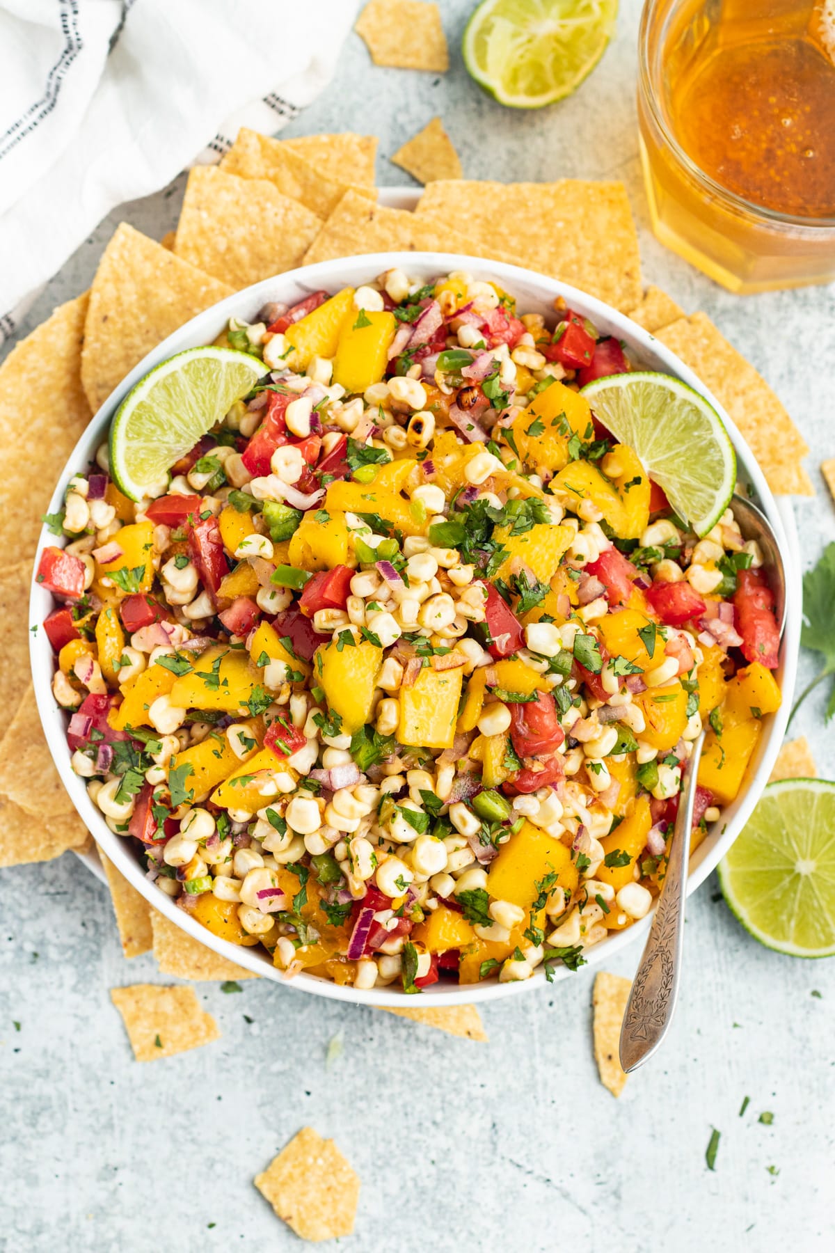 Picture of a bowl with mango corn salsa and chips.