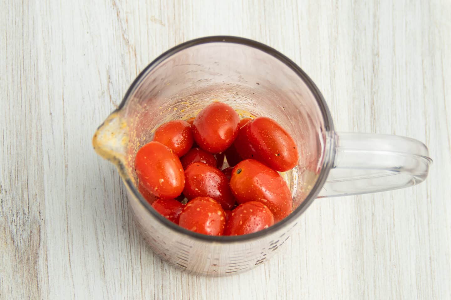 Picture of tomatoes in cup with marinade. 