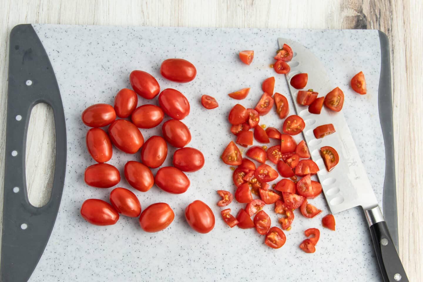 Picture or tomatoes being diced.
