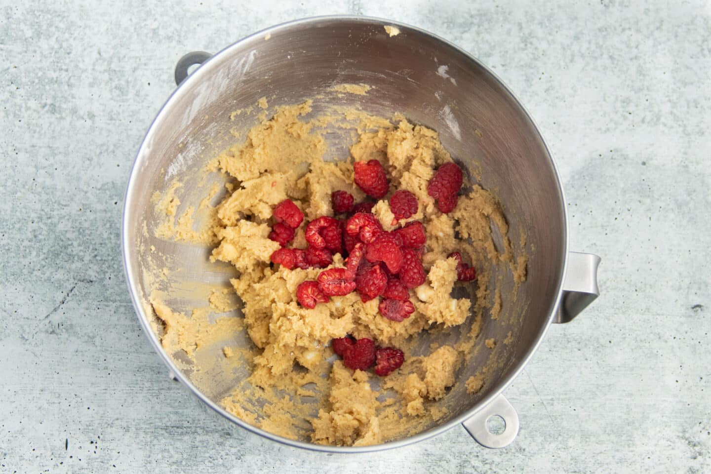 Picture of mixing bowl with added raspberries to mixture.