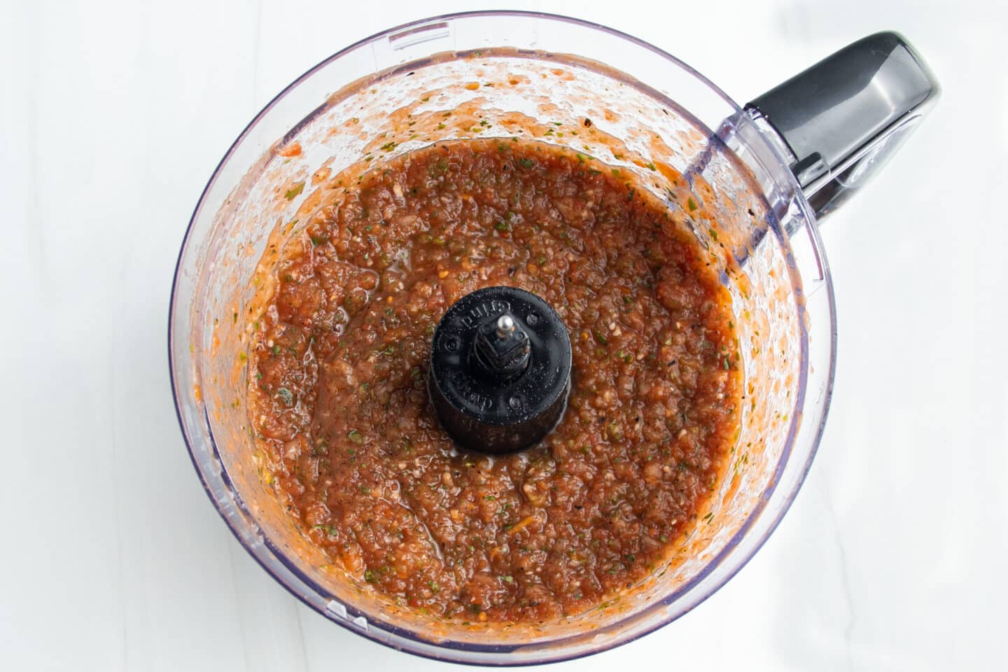 Picture of fire-roasted salsa ingredients in a food processor after blending.