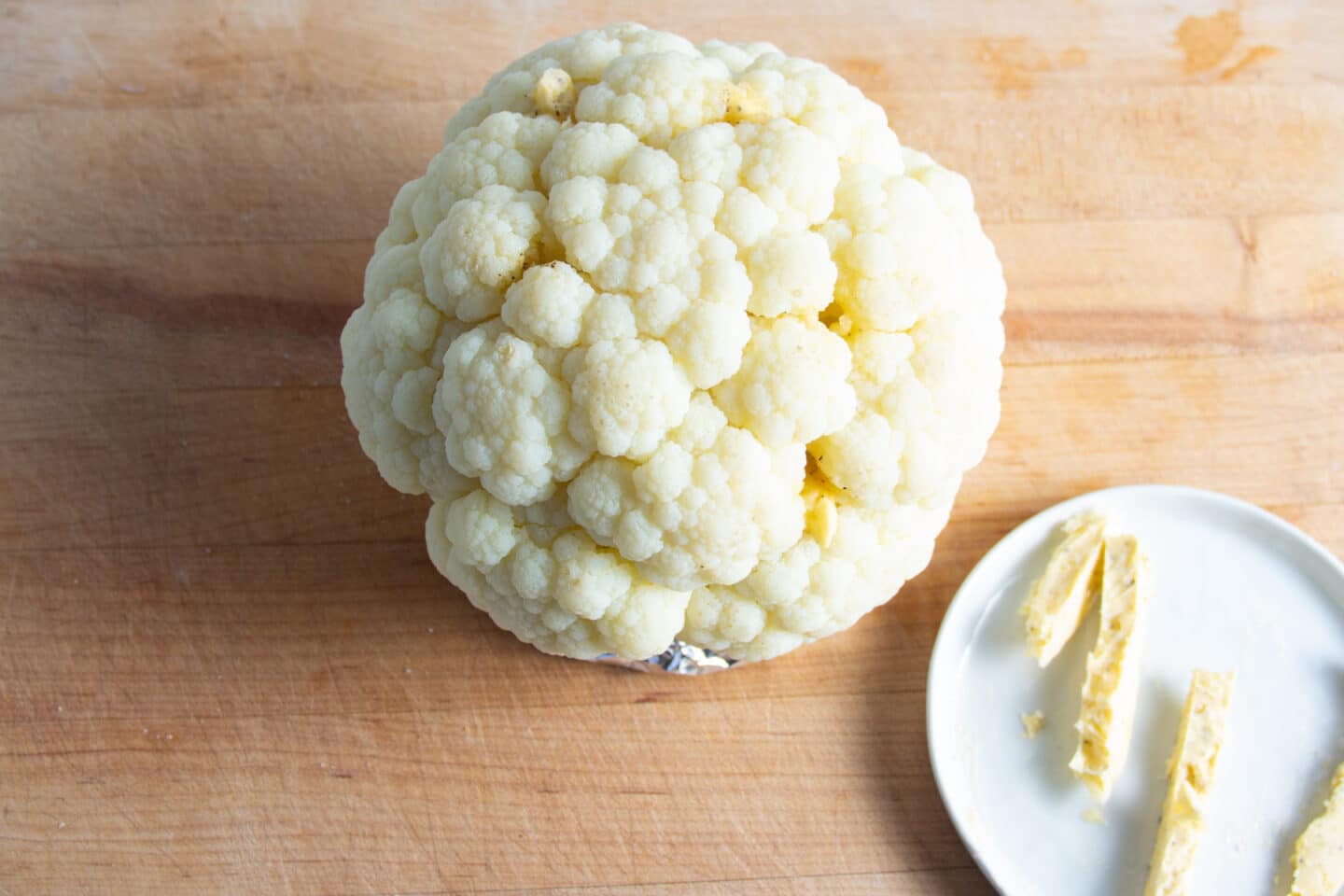 Picture of cauliflower being rubbed with butter.