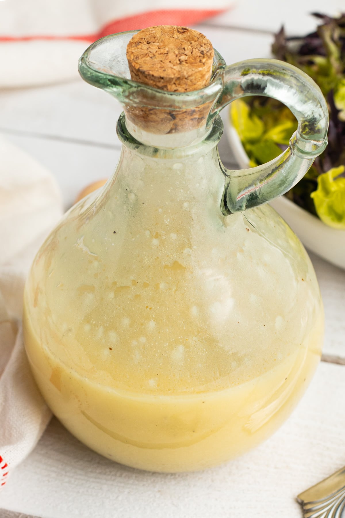 Close up picture of a jar of champagne vinaigrette. 