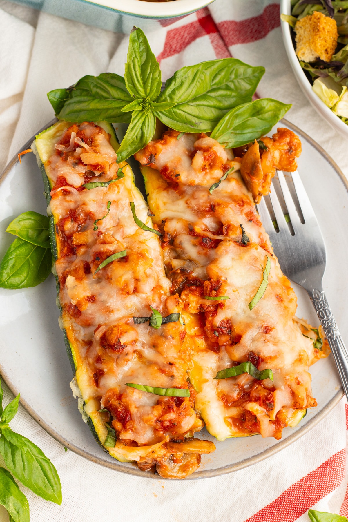 Picture of two zucchini boats on a plate. 