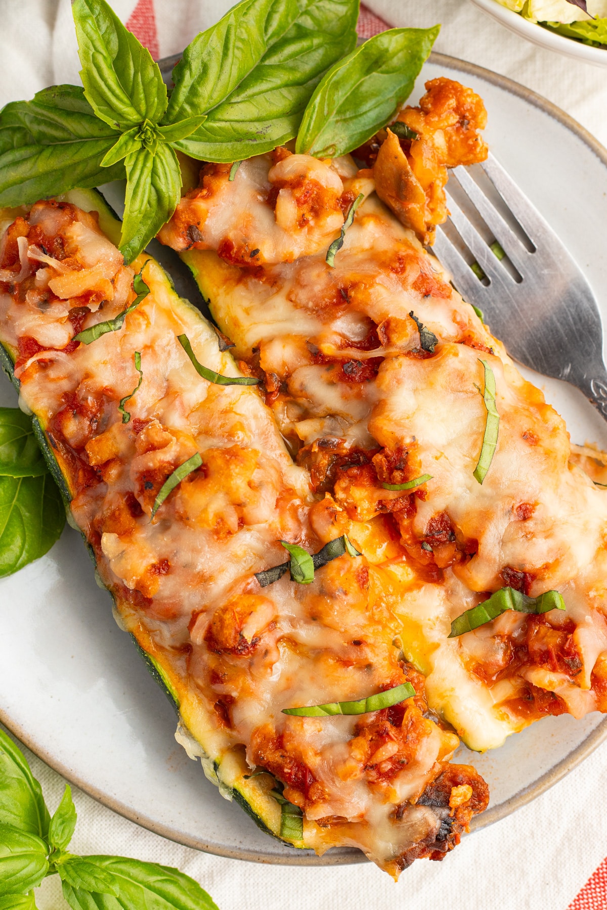 Picture of two zucchini boats on a plate. 