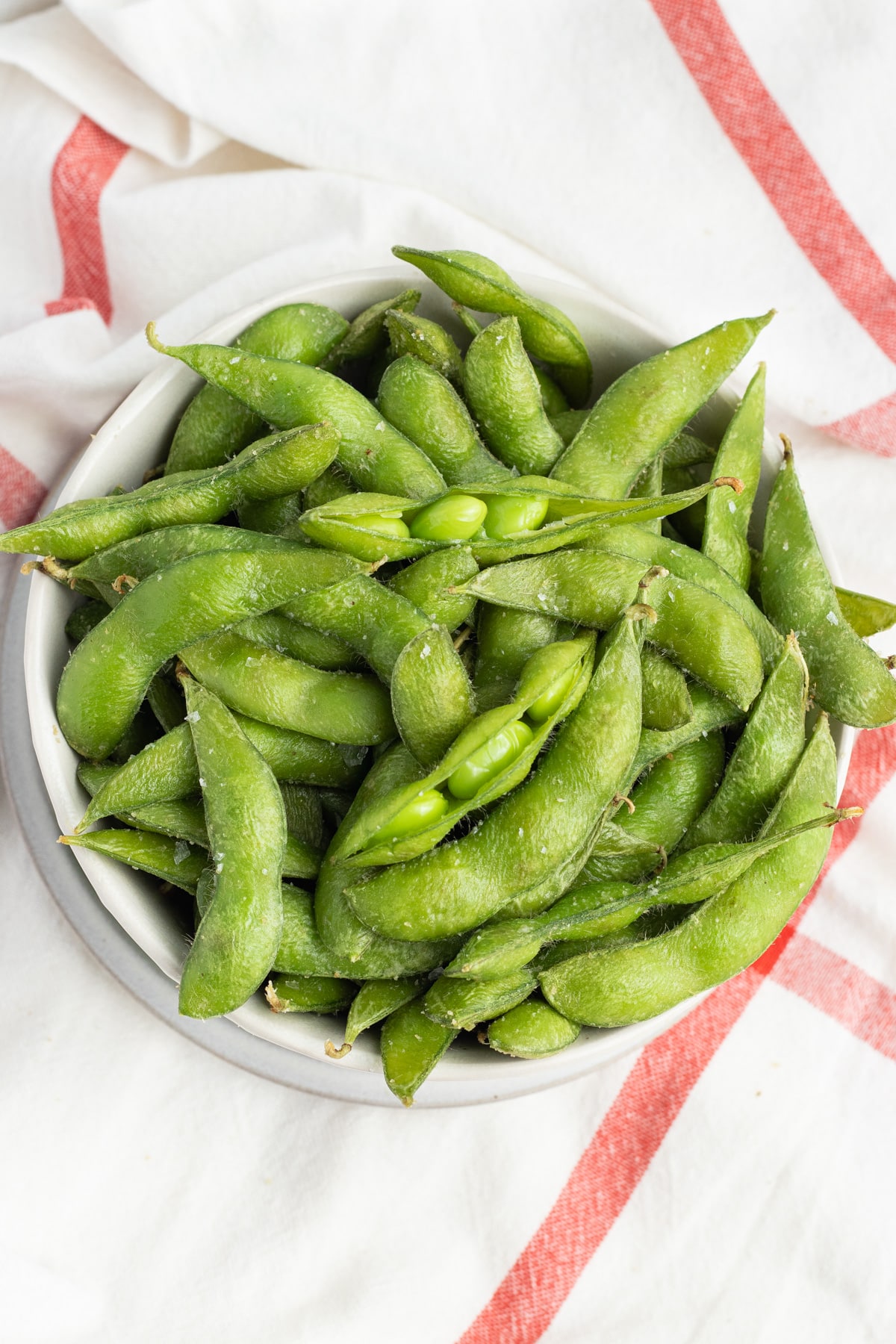 This is a picture of a bowl filled with edamame.