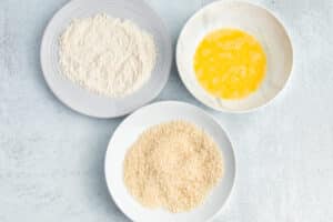 This is a picture of three bowls with flour, egg and panko mixture.