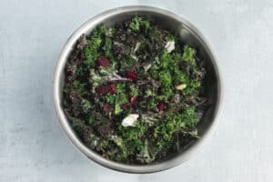 This is a picture of a bowl with the kale salad being tossed.