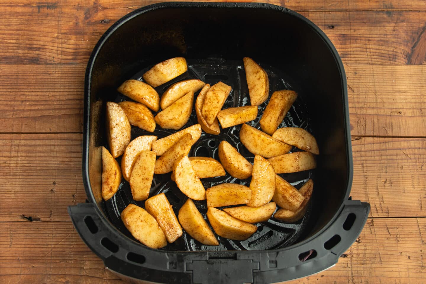 This is a picture of the air fryer basket with the raw apples.