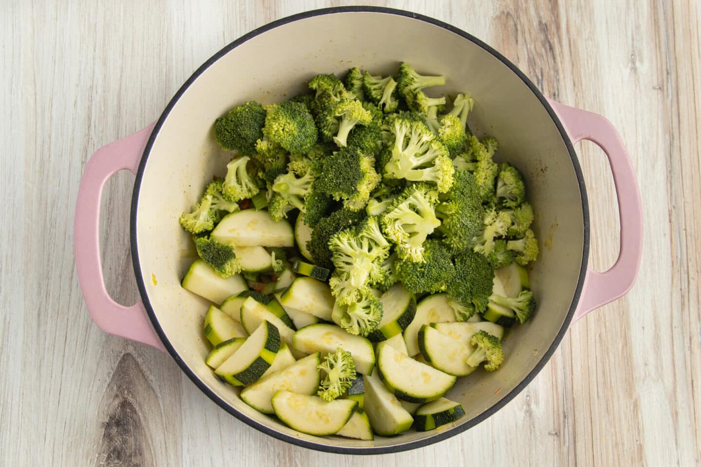 This is a picture of a pot with broccoli and zucchini added.