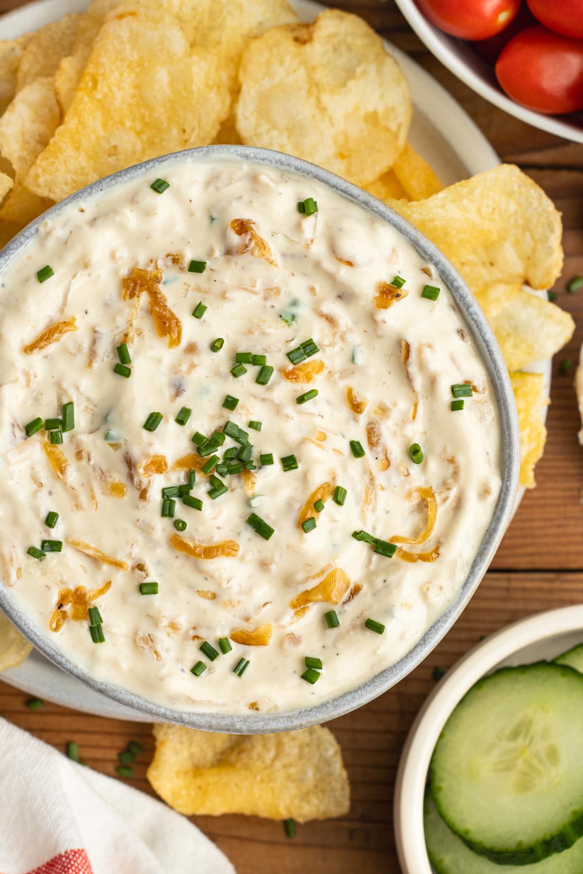 This is a picture of the caramelized onion dip with greek yogurt surrounded with chips and veggies.