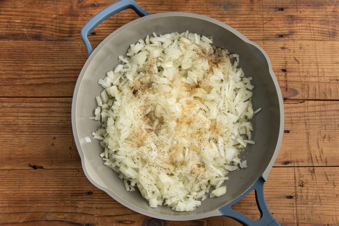 This is a picture of a skillet with the onions and seasoning.