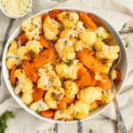 This is a square picture of cheesy roasted carrots and cauliflower.