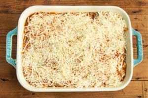This is a picture of the baking dish with the chicken and squash mixture topped with cheese.