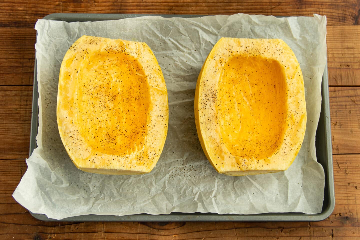 This is a picture of the two halves of the squash with oil, salt and pepper.