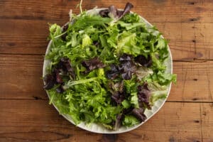 This is a picture of mixed greens with salt and pepper.