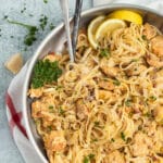 This is a square picture of a skillet filled with chicken and leek pasta.