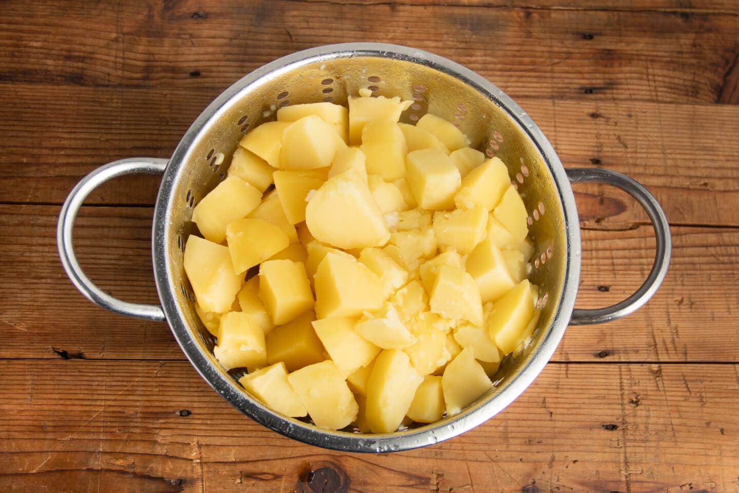 This is a picture of the potatoes being drained in a colander.