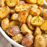 This is a close up square picture of the air fryer parmesan potatoes.