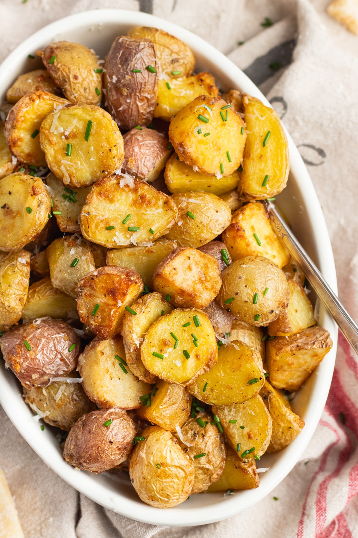 This is a picture of a serving dish filled with air fryer parmesan potatoes.