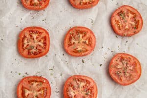 This is a picture of the seasoned tomatoes on a baking sheet.
