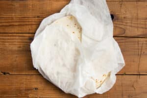 This is a picture of tortillas wrapped in damp paper towels.