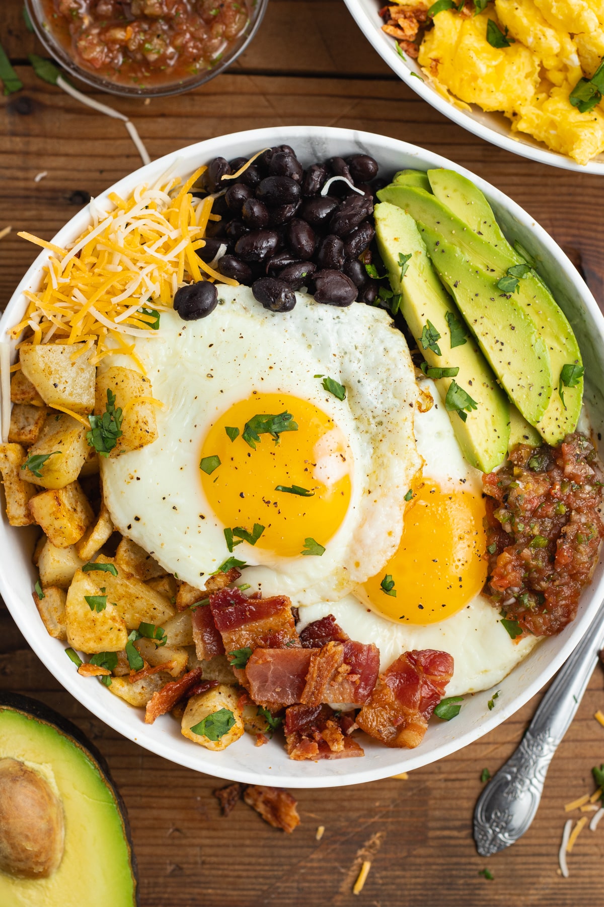 This is a picture of a breakfast burrito bowl with sunny side up eggs.