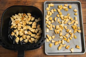 This is a picture of potatoes being cooked wit two methods, in air fryer and on baking sheet for oven.