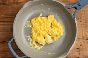 This is a picture of scrambles eggs in a skillet.