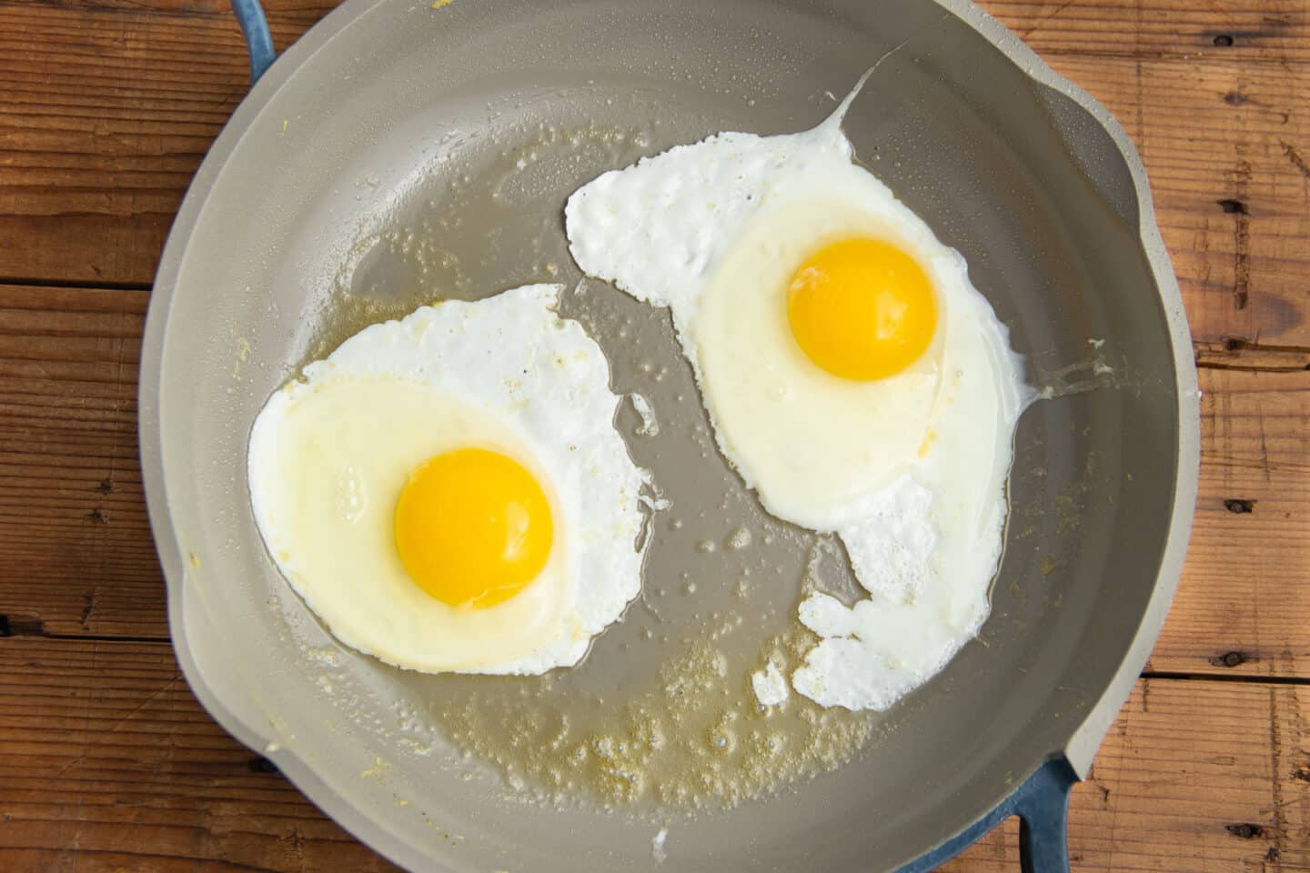 This is a picture of sunny side up eggs in a skillet.