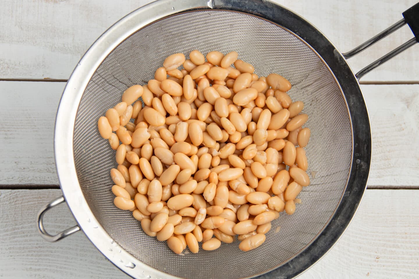 This is a picture of white beans being drained.