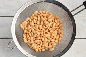 This is a picture of white bean being drained.