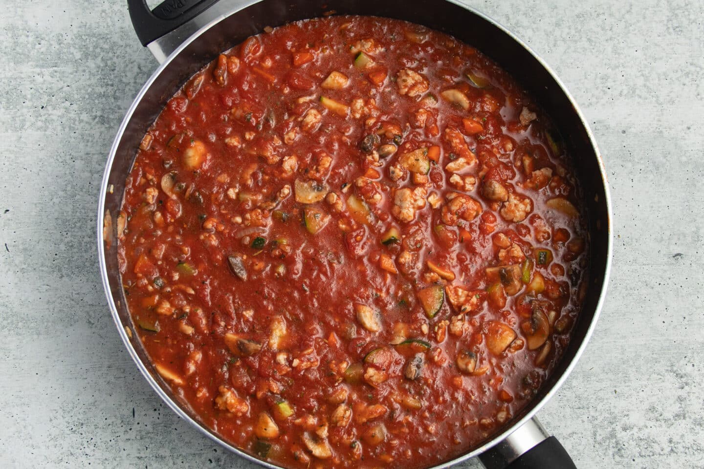 This is a picture of the ground chicken bolognese sauce simmering in a skillet.
